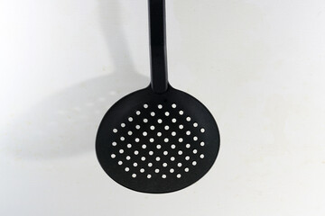 Black kitchen spoons with holes 