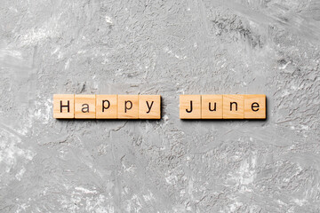 Happy June word written on wood block. Happy June text on table, concept