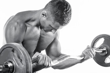 Young muscular man doing bicep barbell curl exercise