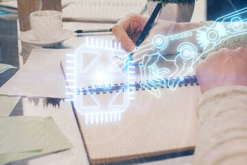 Fototapeta premium Double exposure of writing hand on background with data solution technology hologram. Ai concept.