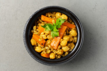 Vegetarian pilaf grey in a pot decorated with greenery close-up view from above