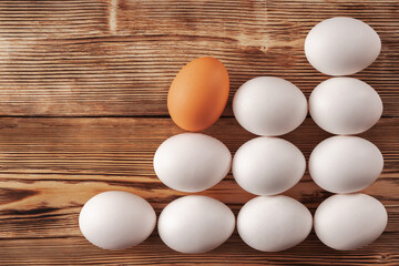 An orange egg goes up a ladder of white eggs.