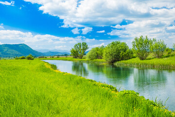 Croatia, beautiful nature landscape, river Gacka flowing between the meadow fields in Lika region