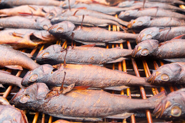 Smoked fish. Smoke. Hot Smoked fish meat. Smoked fish. Perch. Smoked fish background texture.