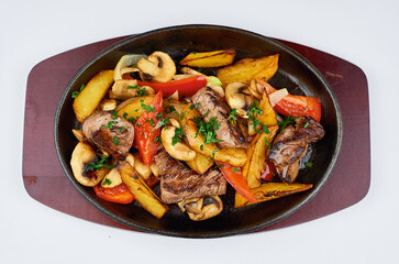 Hot frying pan with meat potatoes and peppers