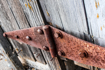 Rusty Hinge on Wooden Door