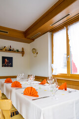 charming and warm table and place settings interior shot of a restaurant table
