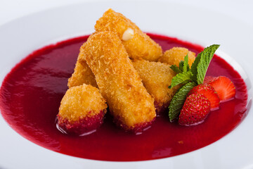 Cheese sticks in strawberry sauce with mint