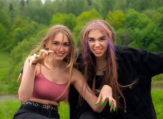 Fototapeta premium Two teenage girls make faces at the camera