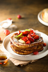 Strawberry French toast with maple syrup and butter