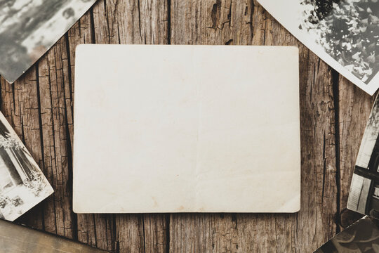 Old vintage photo template (mockup) on wooden background. Empty retro card, textured paper.