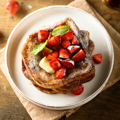 Strawberry French toast with maple syrup and butter