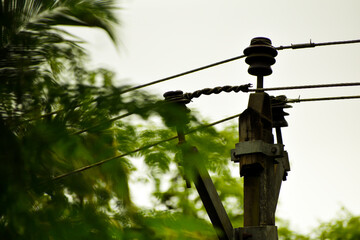 Electricity pole or electricity post. Top of electric post. Electric wire lines connecting to the...