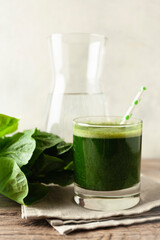 Healthy green smoothie on vintage wooden table. Fresh detox nutrient.