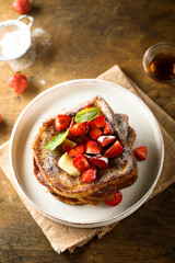 Strawberry French toast with maple syrup and butter