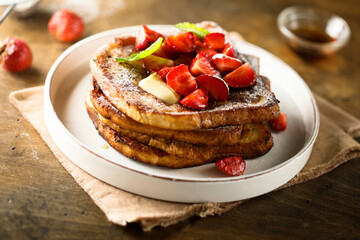 Strawberry French toast with maple syrup and butter