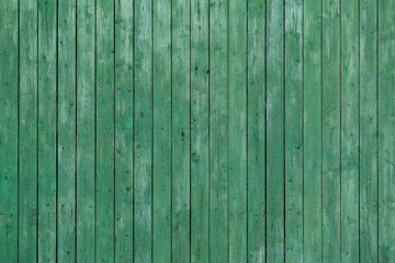Fototapeta na wymiar In einem satten Grün angestrichene Wand aus Holzbrettern oder Latten als Hintergrund