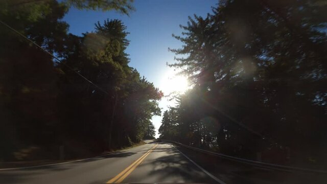 Driving in Big Sur California Cabrillo Highway 1 coast road, pov south, sunflare