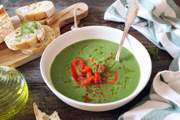 Green pea soup with spinach, olive oil, red grilled bell pepper and dill dressing