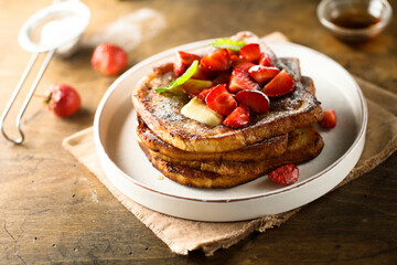 Strawberry French toast with maple syrup and butter