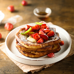 Strawberry French toast with maple syrup and butter