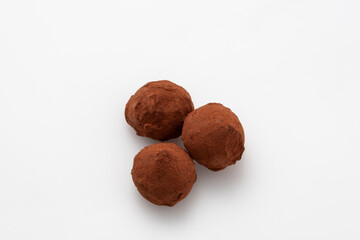 Tasty chocolate truffles on white table, closeup