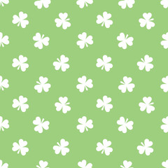 Seamless pattern with cute small three-leaf clover leaves. St. Patrick's day vector illustration with shamrock.