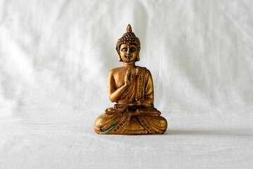 Golden Buddha on cloth background