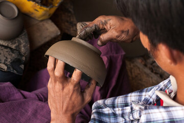 A lacquer-ware worker crafting pottery, Bagan, Myanmar
