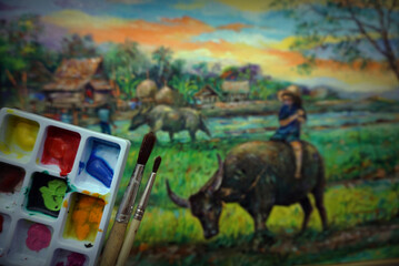 Palette and paintbrush ,  Art painting Oil color Hut northeast Thailand Countryside , Child riding a buffalo