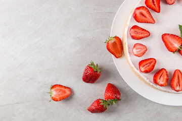 Sweet breakfast, delicious cheesecake with fresh strawberries and mint, homemade recipe without baking, on a stone table. Copy space.
