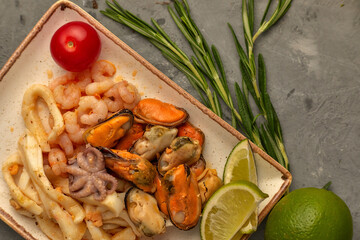 sea cocktail on a plate with lemon and rosemary
