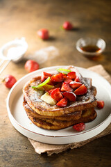 Strawberry French toast with maple syrup and butter