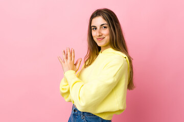 Young woman over isolated pink background scheming something