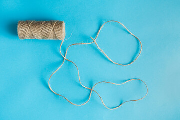 Jute twine on the blue background. View from top, copy space. 
