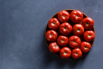 Ripe tomatoes on grey background