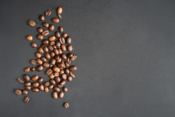 Fresh coffee beans on the grey table background. 