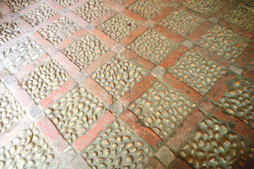  A brick laid floor in a diamond pattern inlaid with beach pebbles to create this Victorian floor of diamonds with quartz cobbles. Simple and enduring. idea for indoors or outdoors.