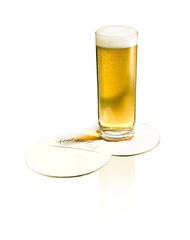 The german beer Koelsch in a glass with two beer mats.