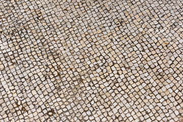 Beige cobblestone pavement seen from above, drone view.