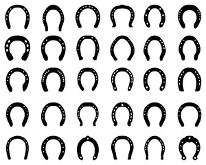 Black silhouettes of horseshoe on the background