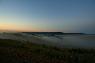 A plane sitting on top of a grass covered field