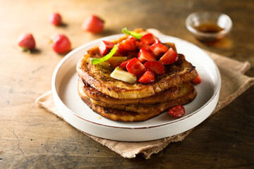 Strawberry French toast with maple syrup and butter