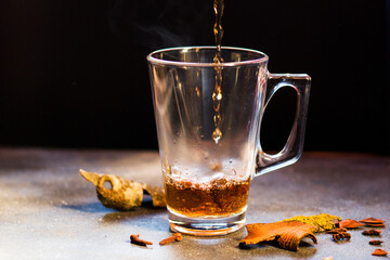 Hot grog on the table, rum and tea with cinnamon and clove.