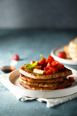Strawberry French toast with maple syrup and butter