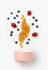 Berry, corn flakes and yogurt pours in ceramic bowl for cooking homemade breakfast