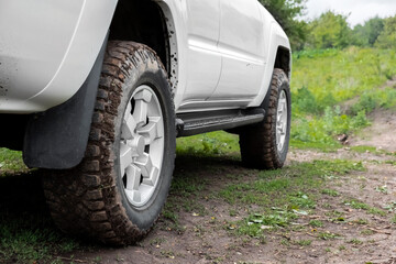 Fototapeta na wymiar Mud tyre off road closeup background. Extreme sport concept. Road trip concept. Offroad car.