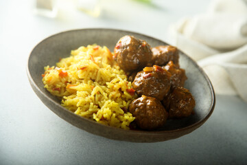 Homemade meatballs with spicy rice