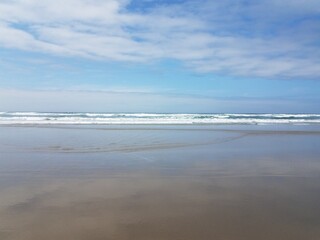 Fototapeta na wymiar ocean water and sand at the beach in Newport, Oregon