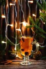 Cup of tea with ginger and cinnamon on wooden background